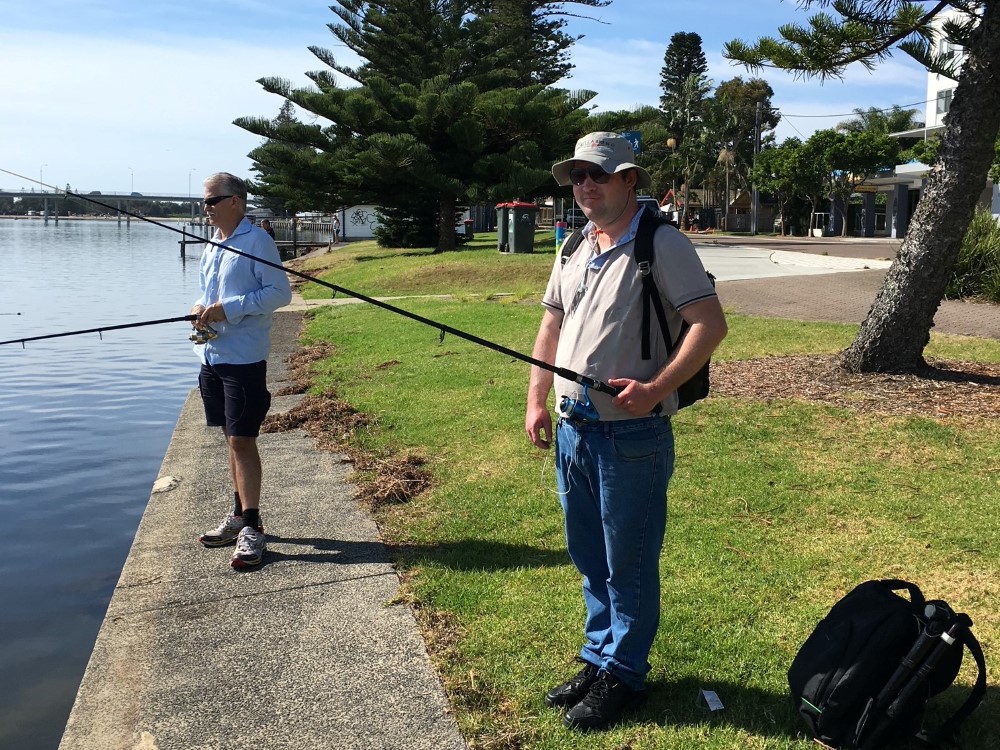 Young man and old man fishing 