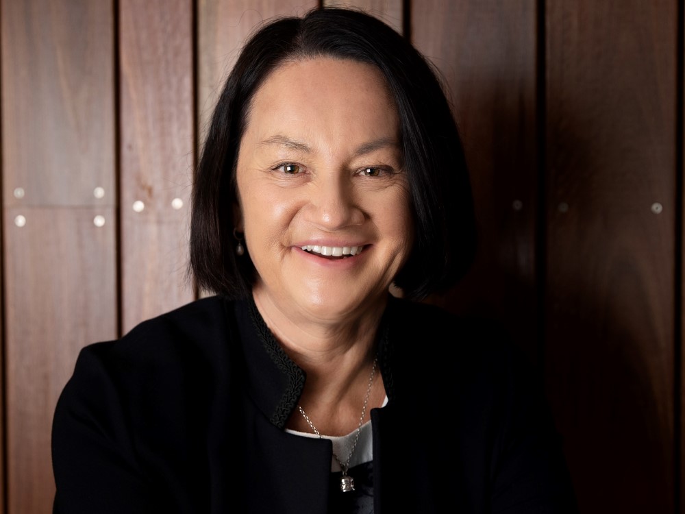 Portrait of middle aged woman with black bob smiling at the camera