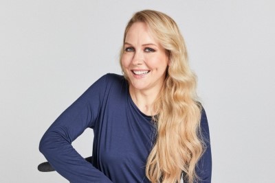 Blonde woman smiling at camera in wheelchair