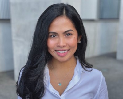 Young woman with black hair smiling at camera