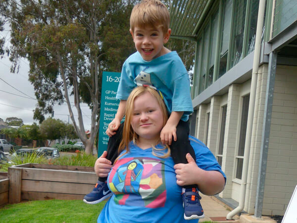 Melissa and young boy wearing Kirkman by Melissa Kirkman t-shirts