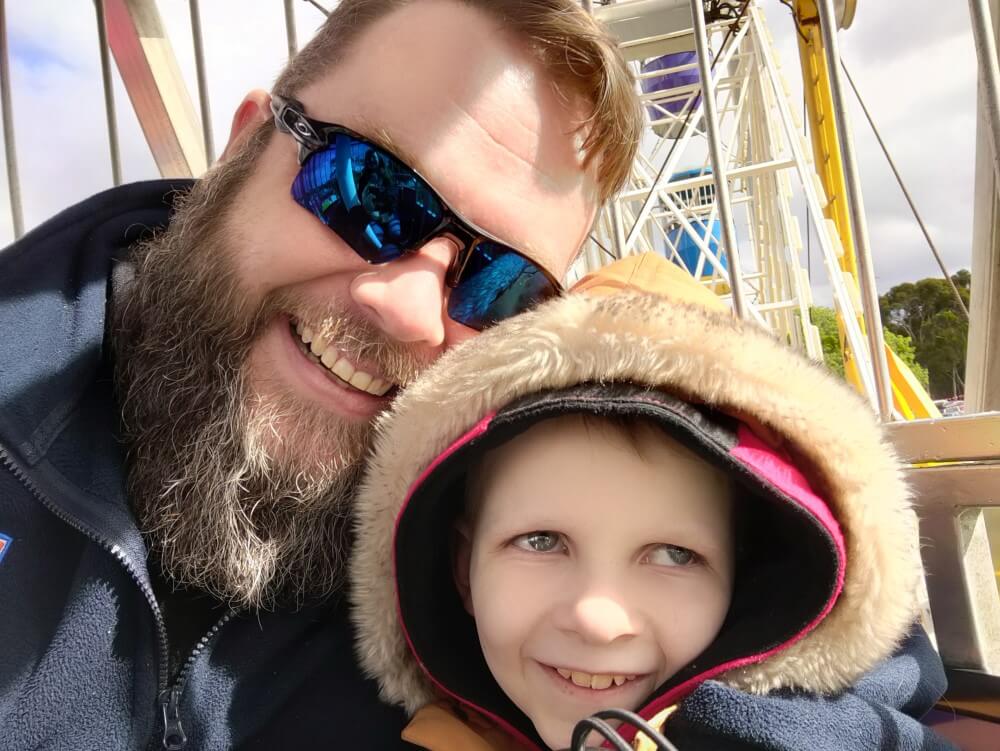 Selfie of bearded man and little boy on ferris wheel