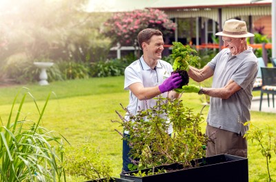 Man and senior man gardening together