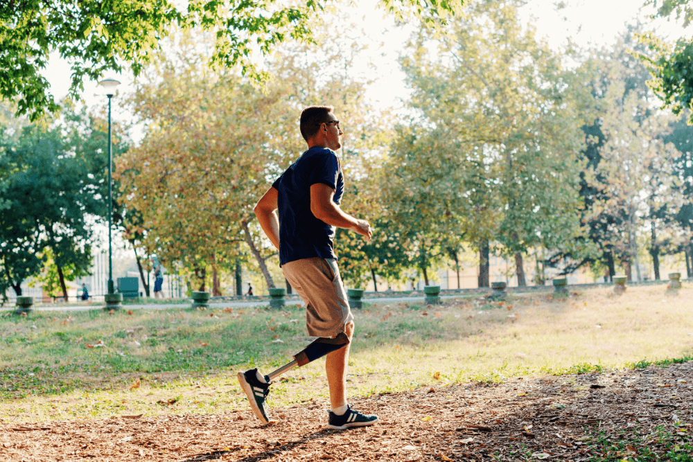 Man with one prosthetic leg jogging outside