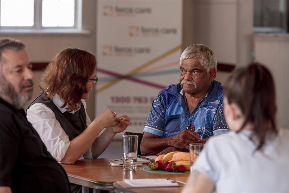 Woman and Aboriginal man talking at table