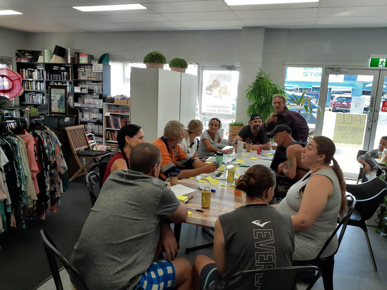 10 people sitting around a table. They are deep in discussion.