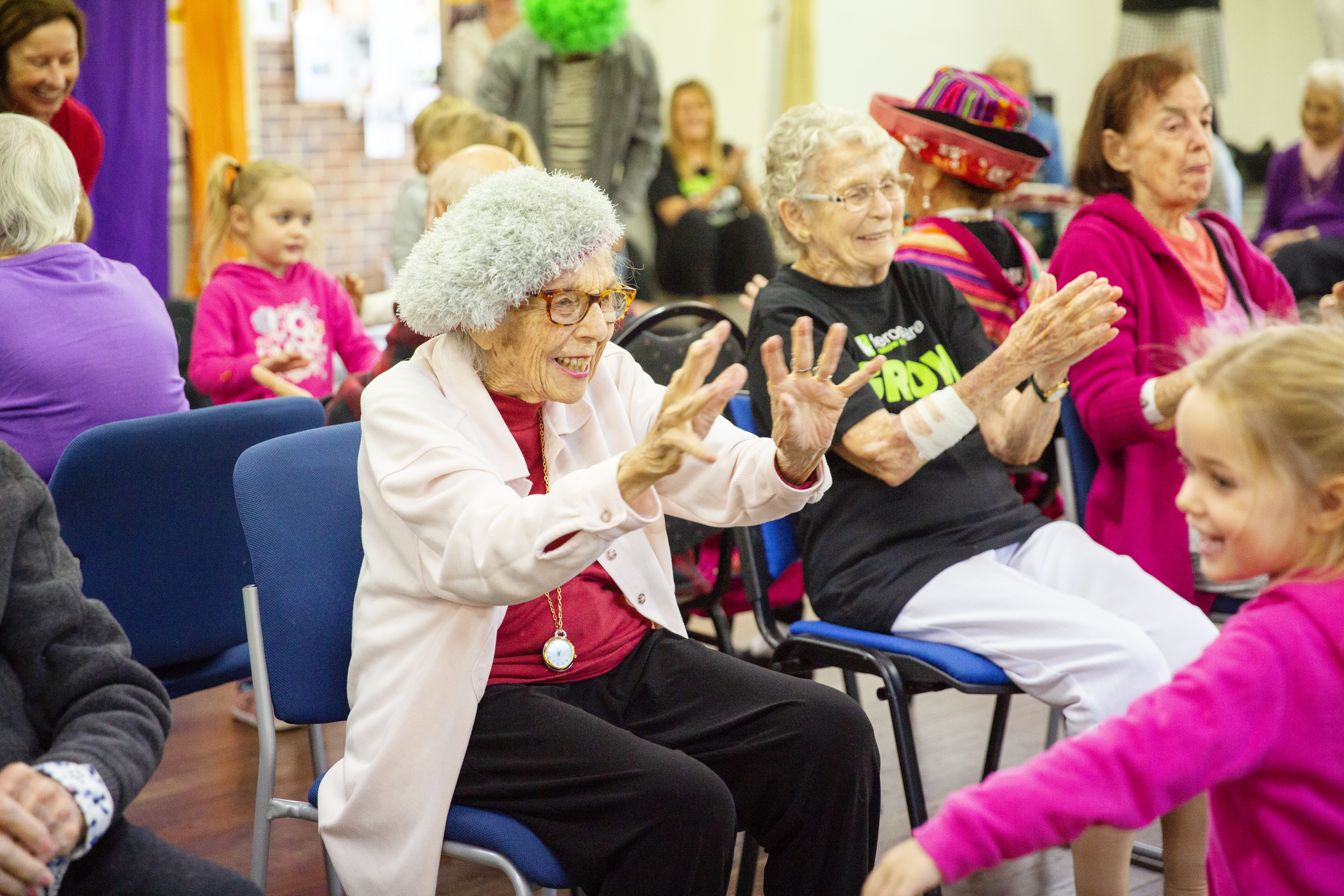 Elderly lady dancing with little girl