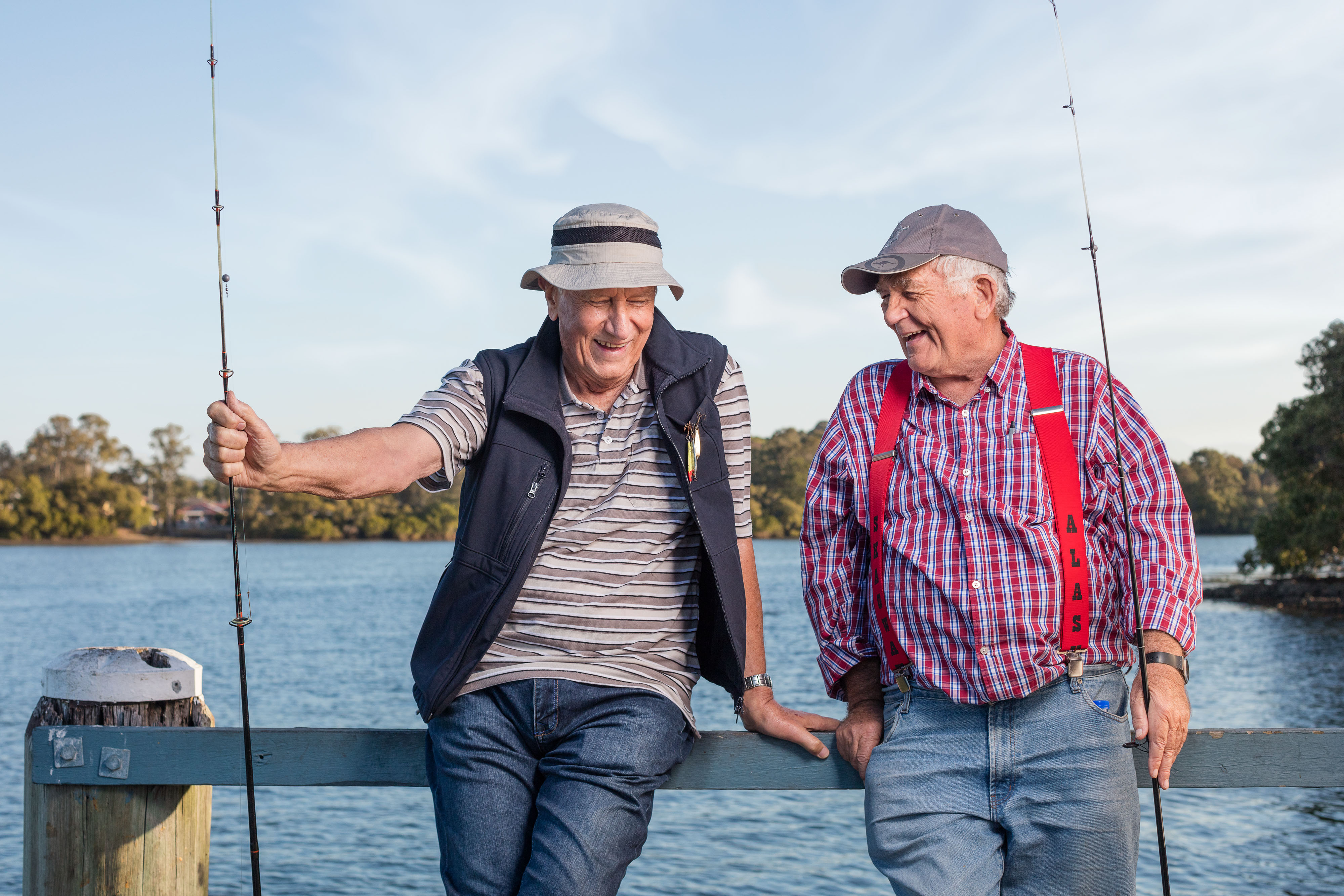 Two men chatting with fishing rods on jetty