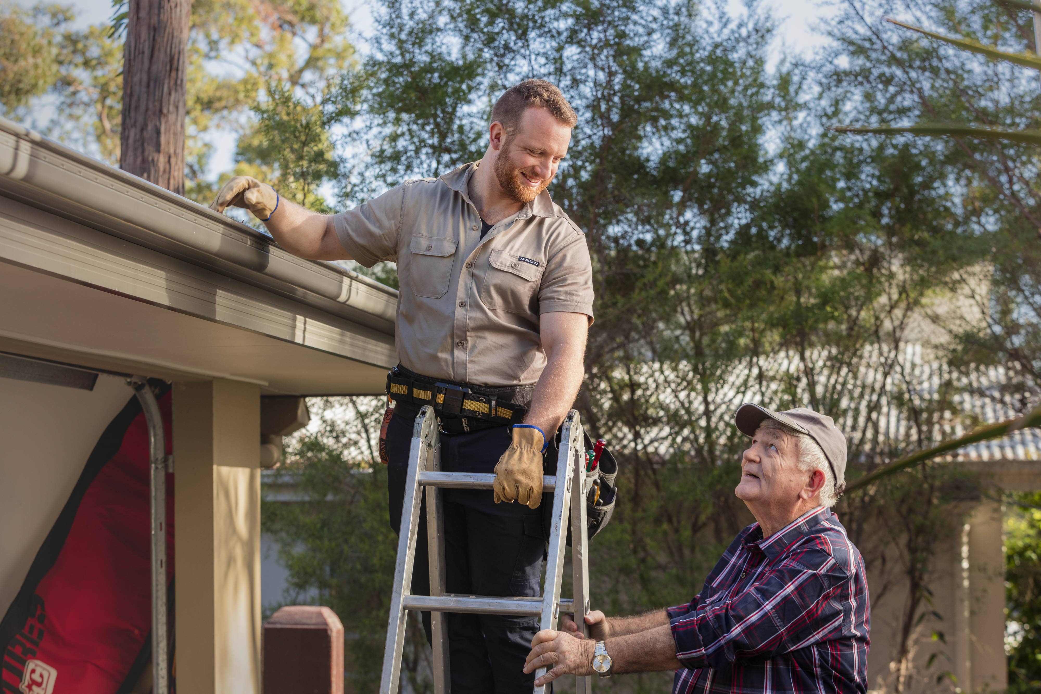 Senior getting help with gutter cleaning