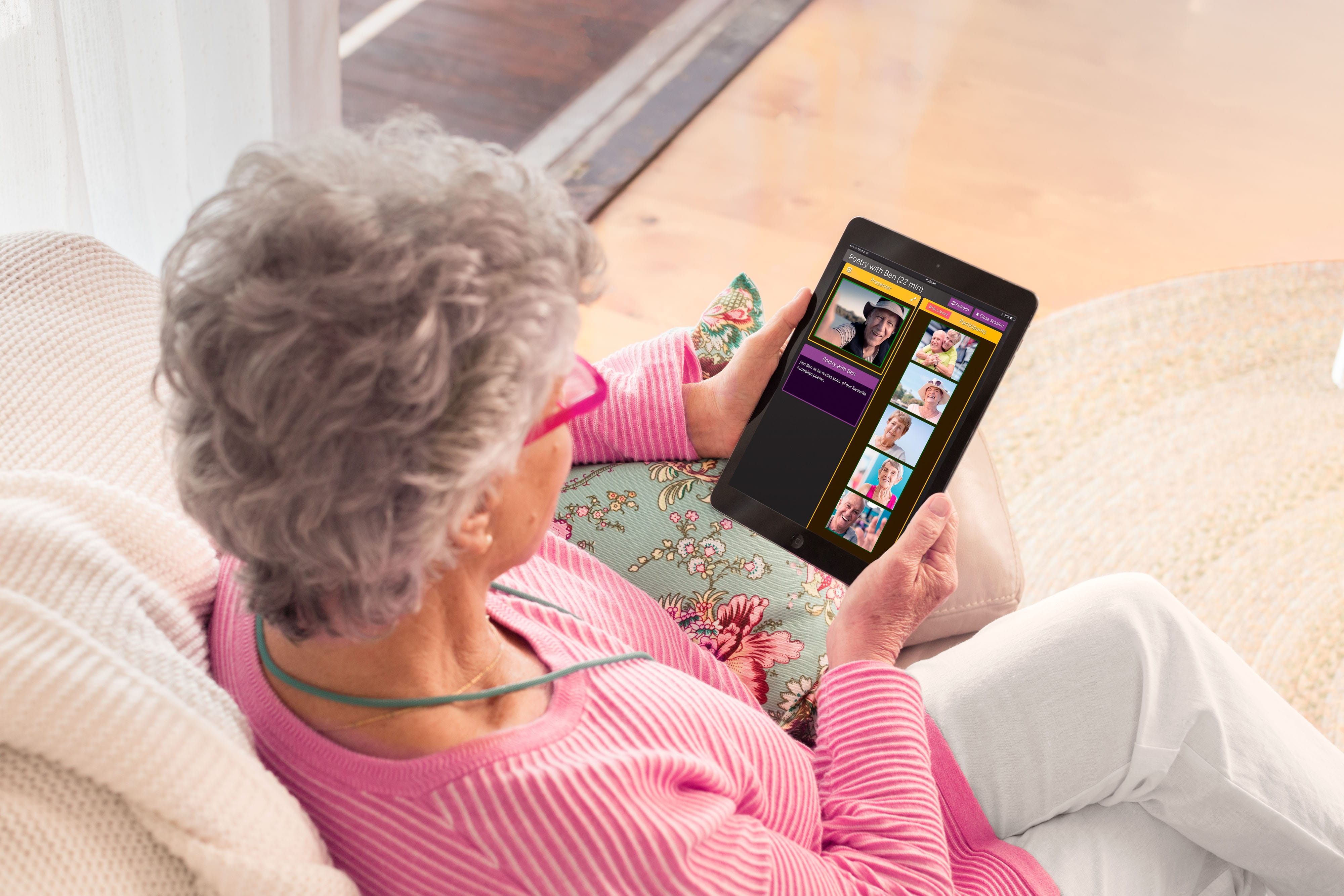 Lady with ipad participating in an online group session 