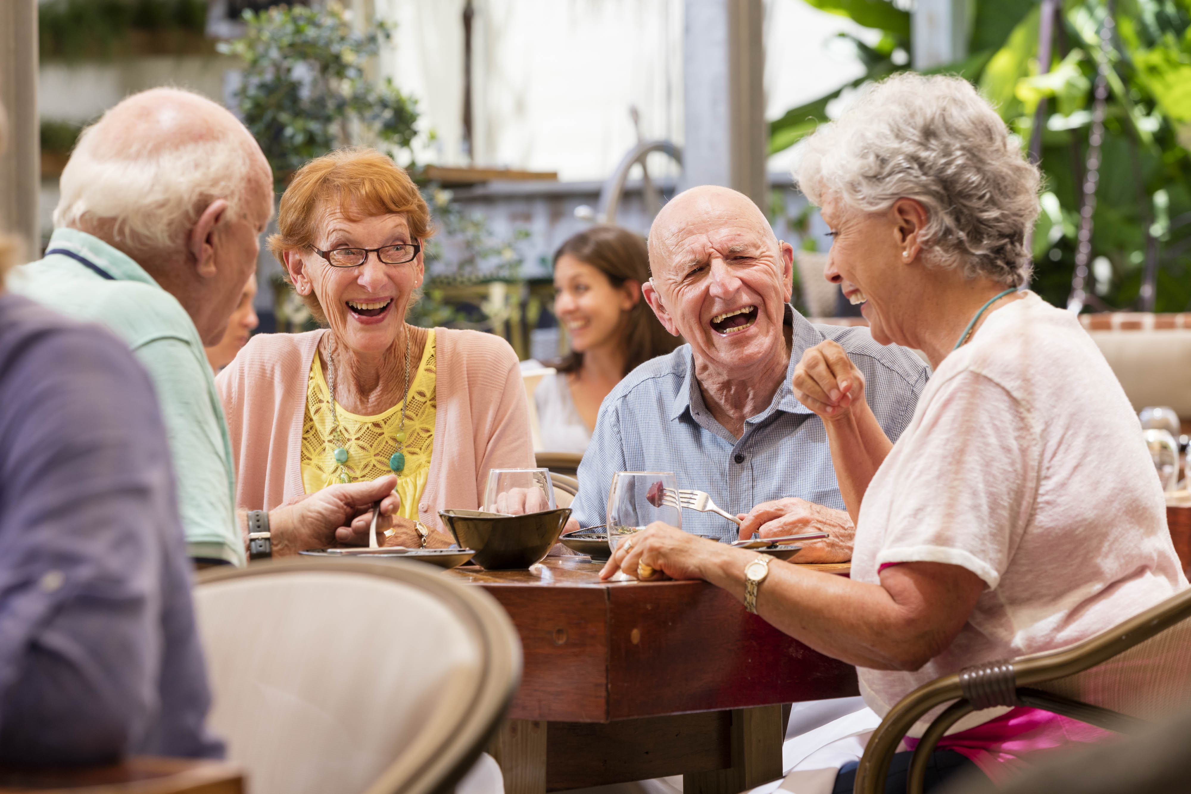 Seniors sitting at table and laughing