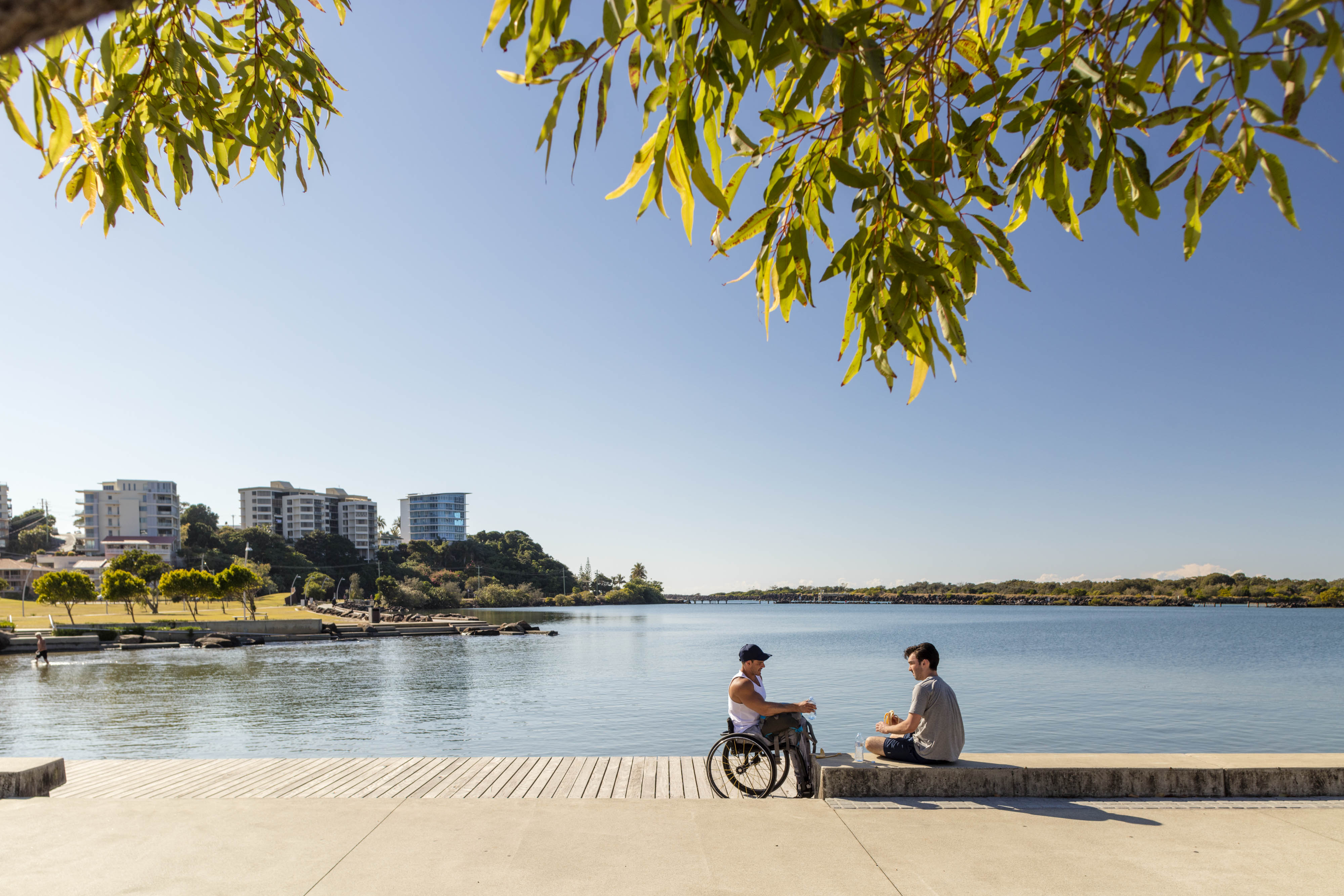 Man in wheelchair next to lake