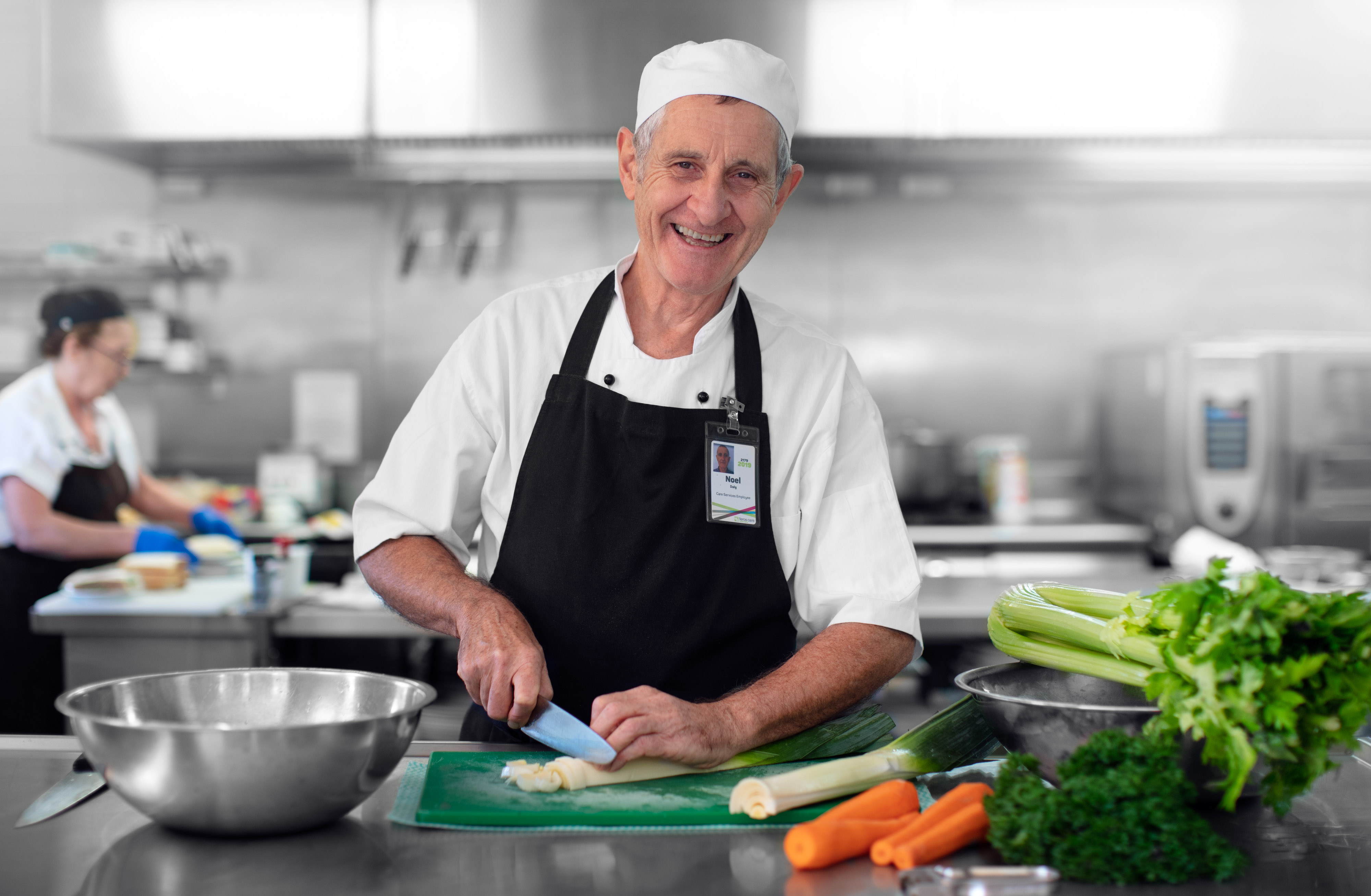 Man cooking in aged care village kitchen