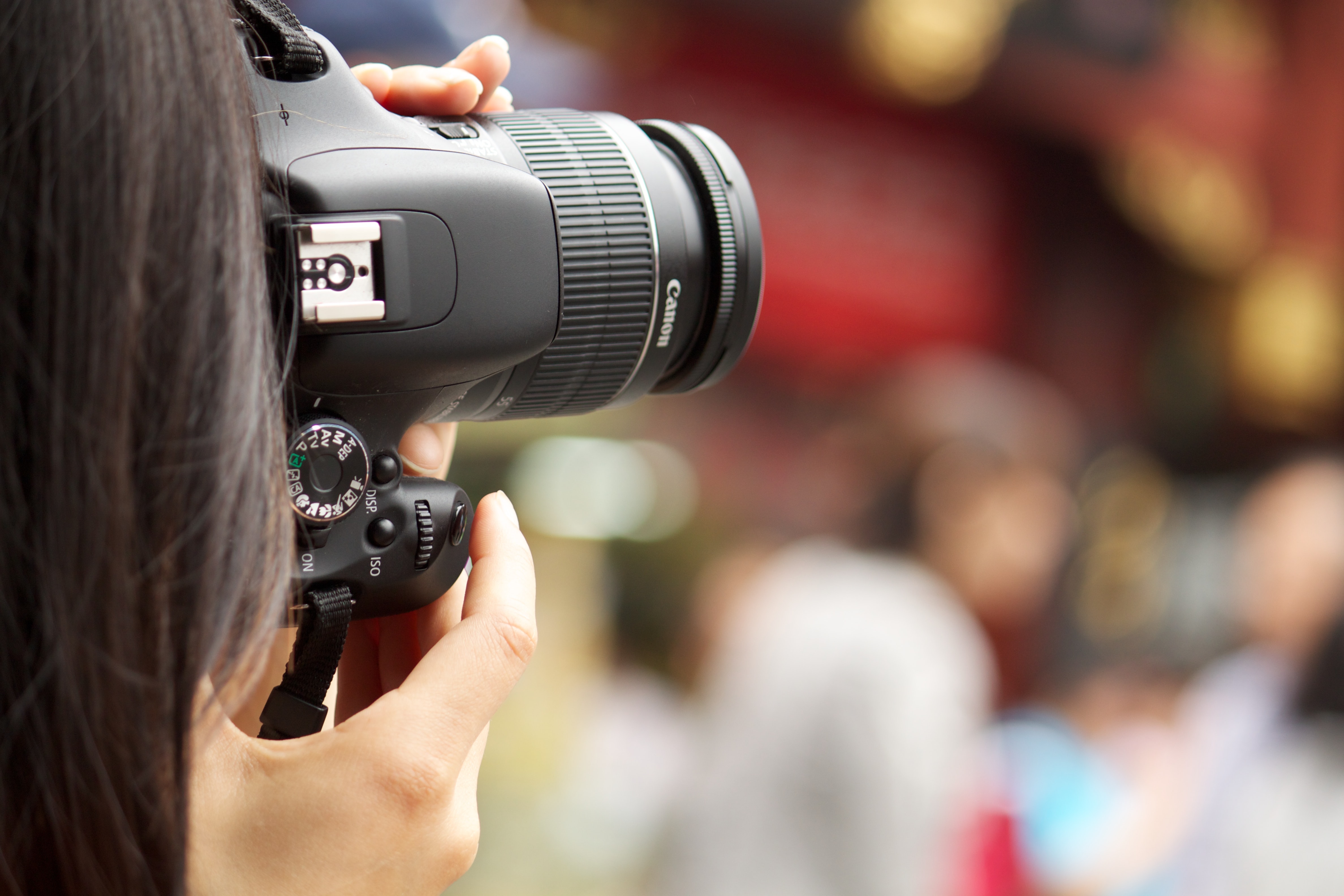 Woman taking a photo with DSLR camera