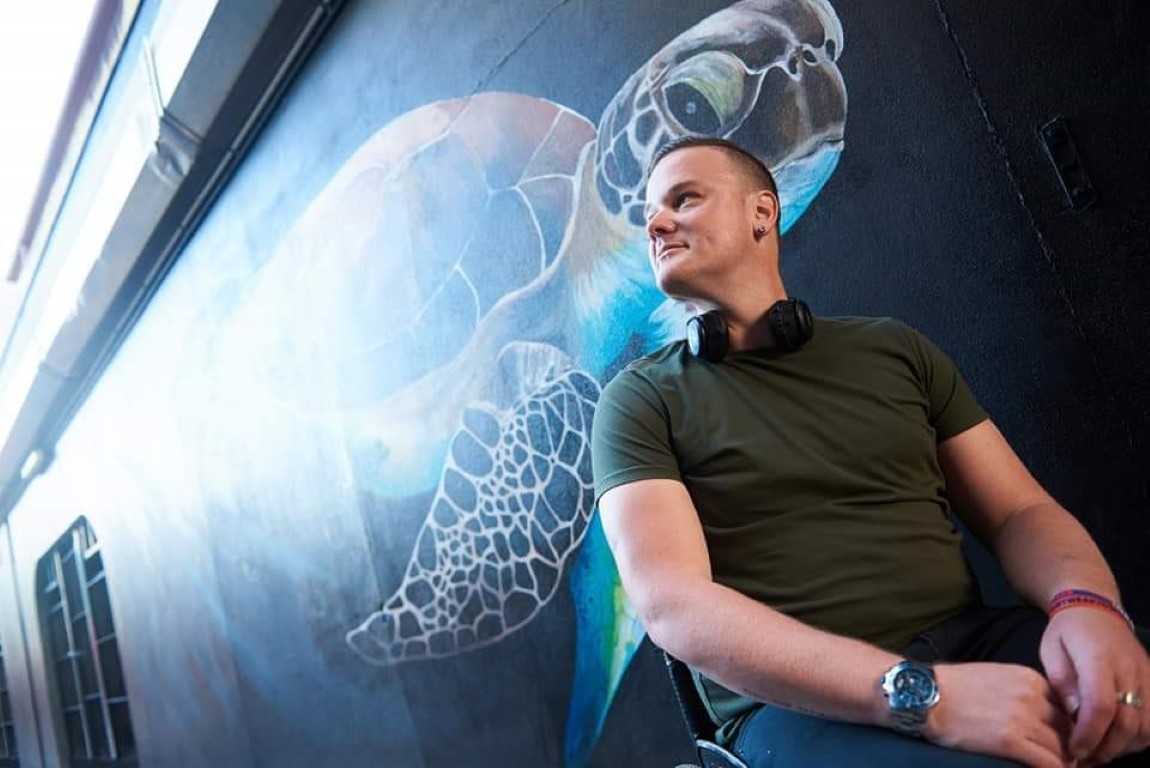 Man in a wheelchair sitting in front of mural 