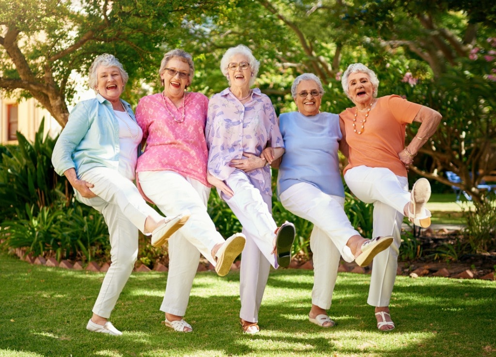 Senior ladies dancing together outside 