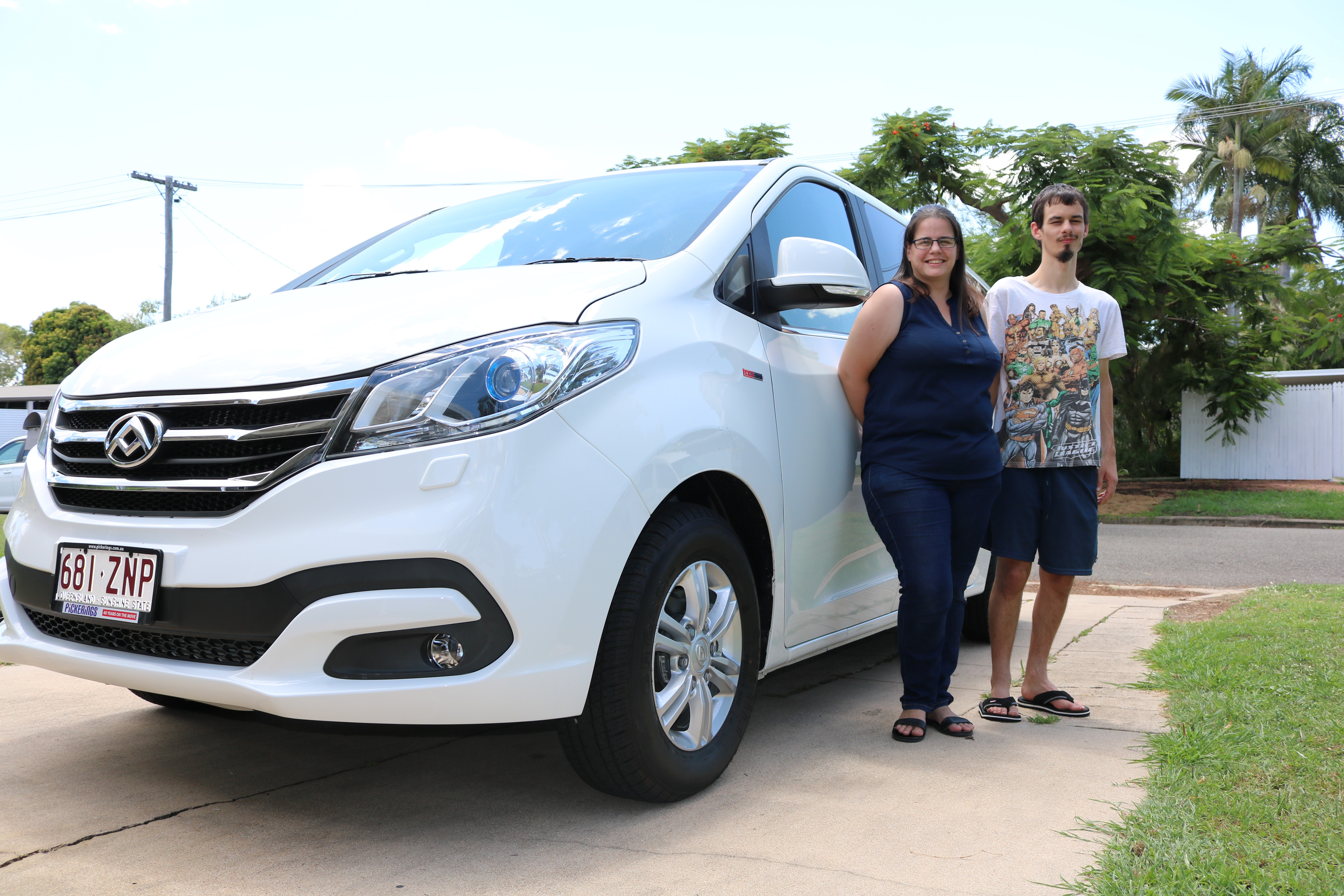 Woman and man standing in front of their new van