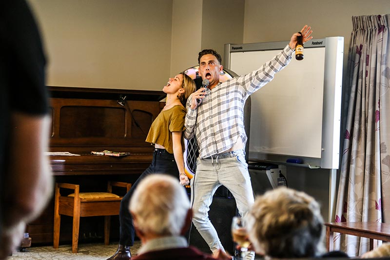 Seniors and volunteers singing karaoke 