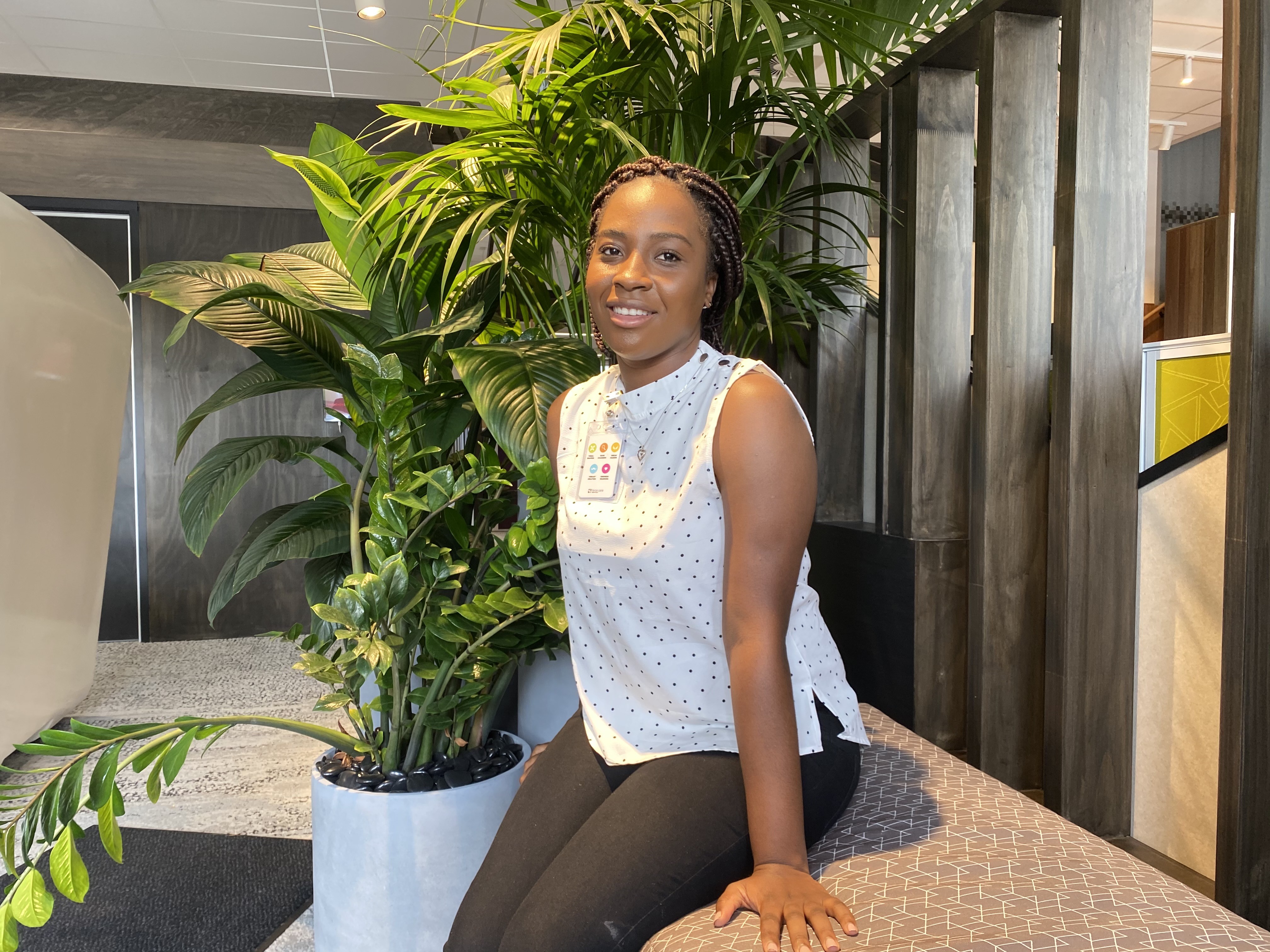 Girl sitting in front of indoor plants