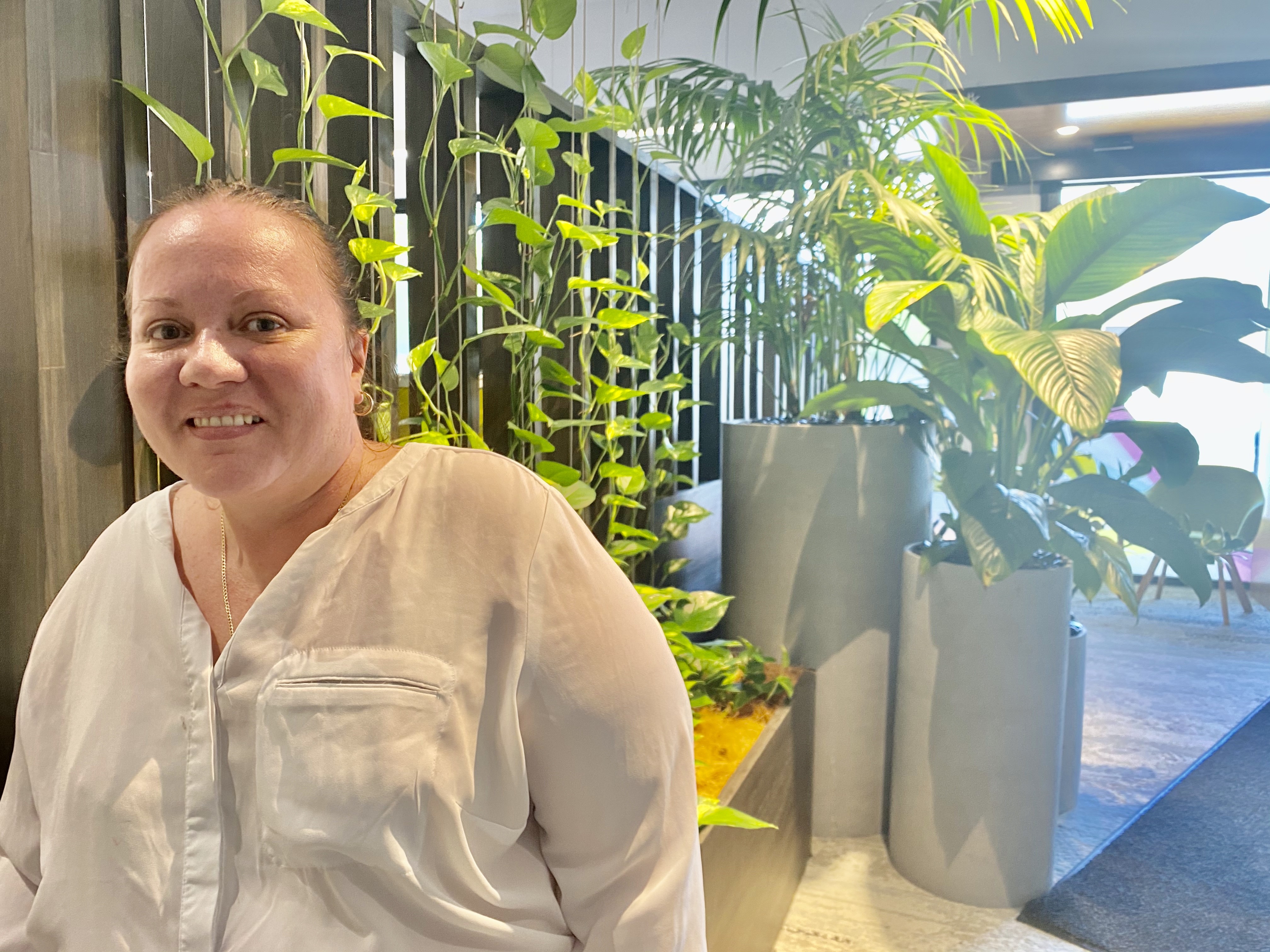 Woman standing in front of indoor plants