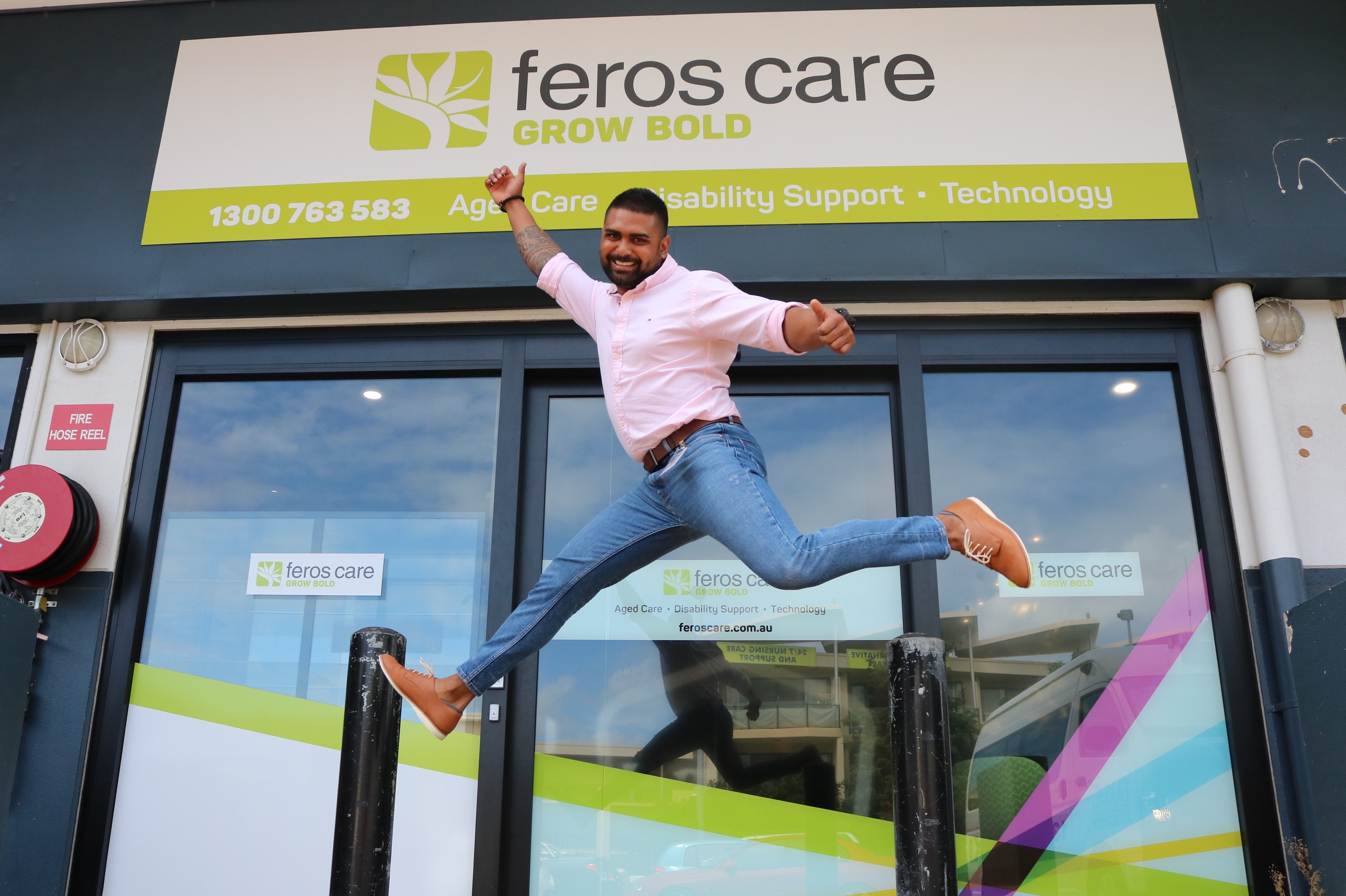 Man jumping in front of Feros Care door 