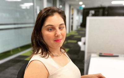 Brunette, blind woman sitting in an office