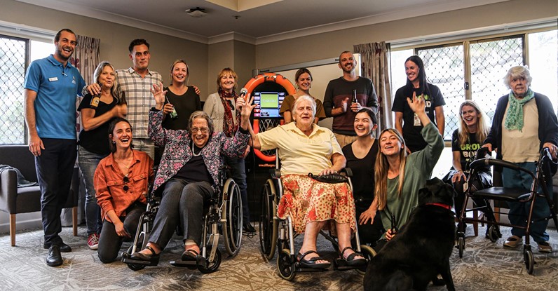 Group of seniors and volunteers singing karaoke