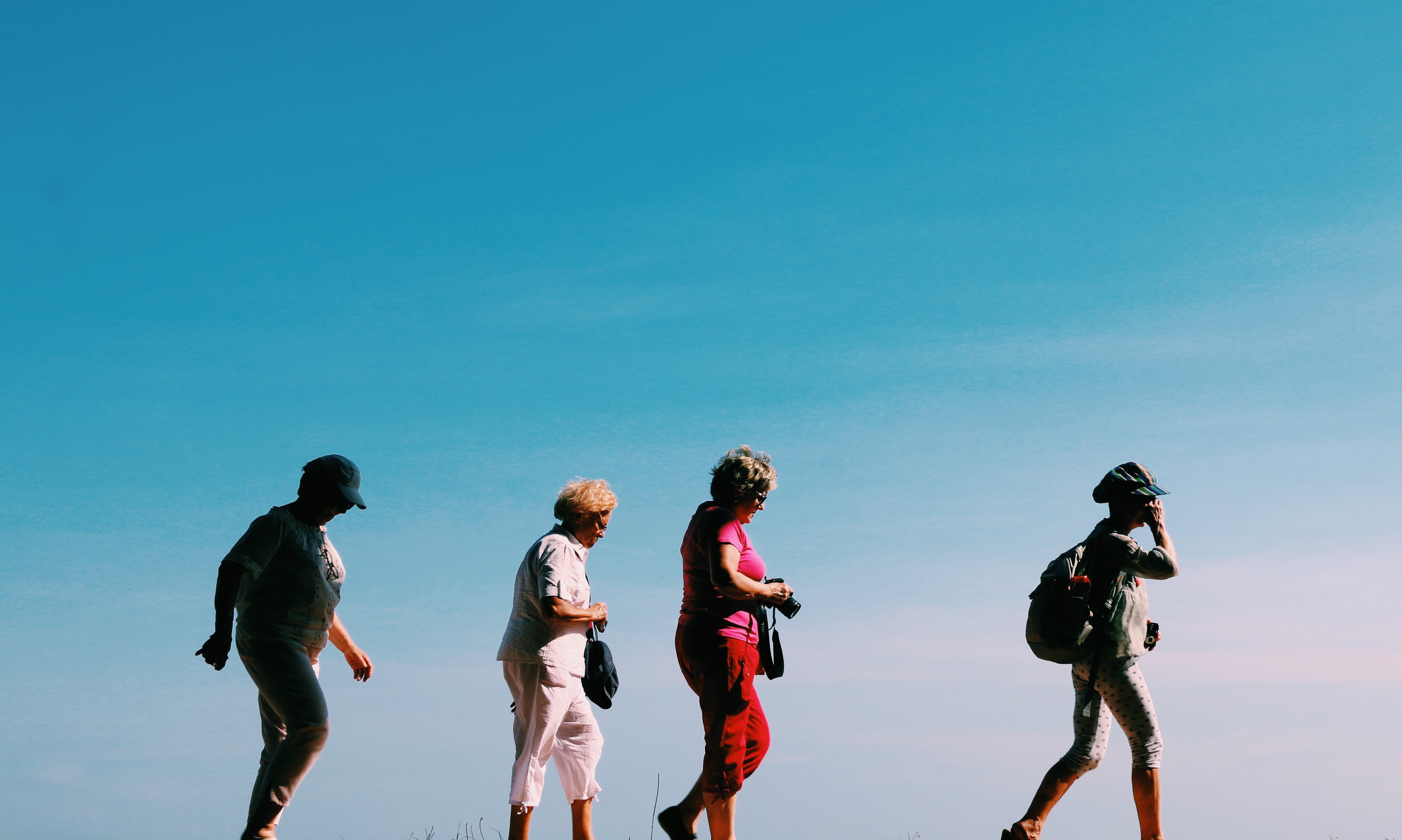 Four senior women hiking 