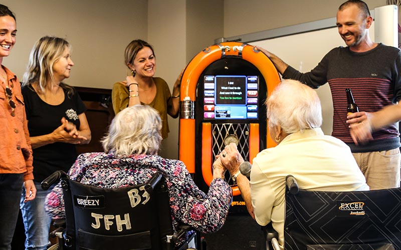 Seniors and volunteers singing karaoke