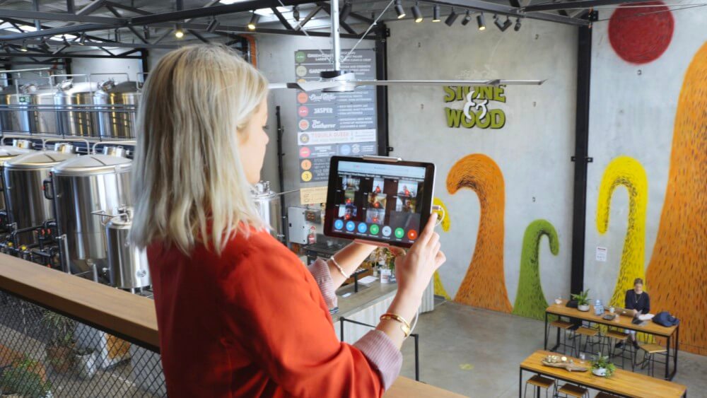 Woman doing a virtual tour of Stone & Wood brewery