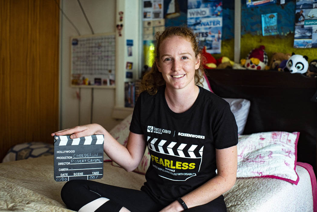 PhotoofChelseannsittingonherbedholdingclapperboard