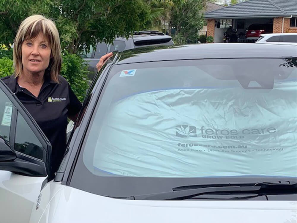 Photo of Janene next to Feros car