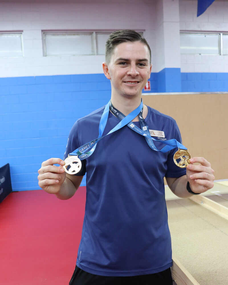 Photo: Man with two SWISH table tennis medals