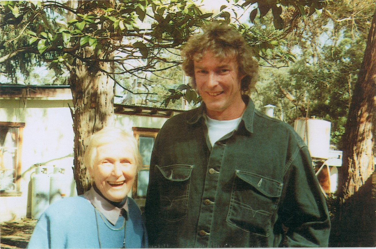 Old scanned film image of a man and an elderly lady smiling at the camera