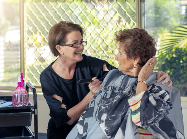 Photo of senior with hairdresser