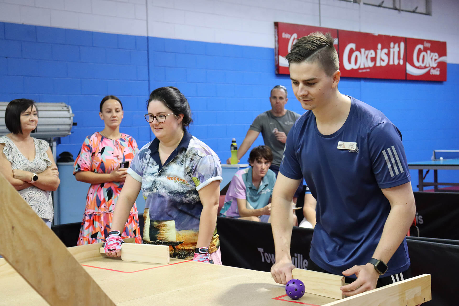 Two people playing swish table tennis